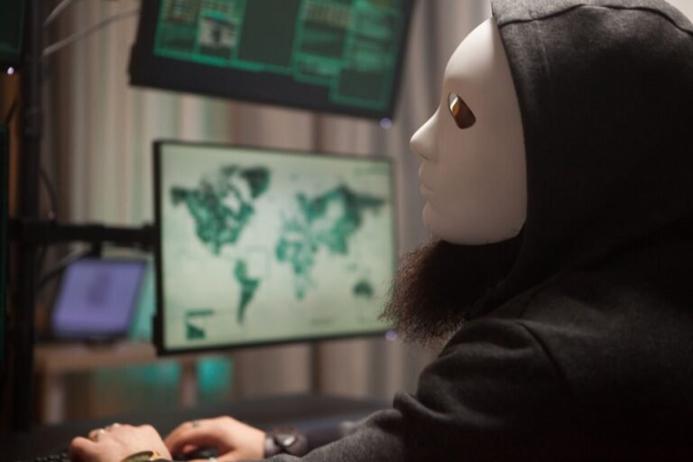 bearded hacker with hoodie wearing white mask using his computer with multiple screens 482257 22966